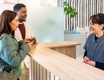 Patients at checkout counter paying for services