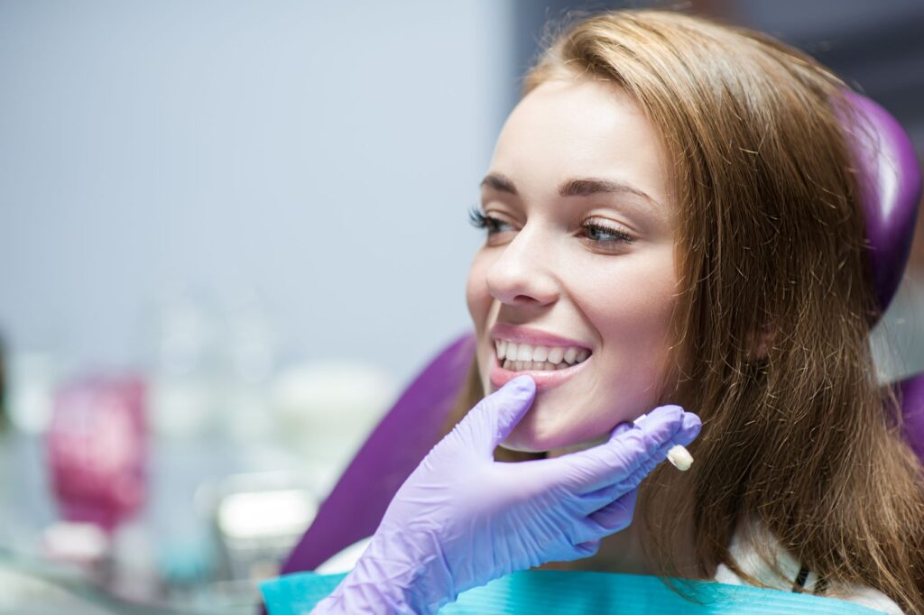 Woman in dental chair being examined for denal crown