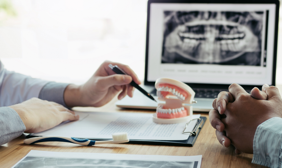 Dentist showing patient dentures